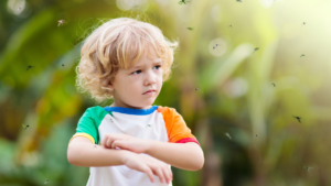 A close-up of a child itching because of mosquito bites